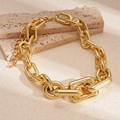 Close-up of golden chunky chain necklace with mirror-polished metallic links and lobster clasp - Gold