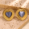 Macro shot of vintage heart stud earrings with blue gemstone and gold bead texture - Grey Blue