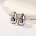 Minimalist silver teardrop stud earrings with a polished metallic finish on marble - Small Silver