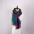 Close-up of colorful British plaid scarf with fringe tassels on a display model - Rose Red
