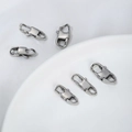 Polished silver stainless steel lobster clasps for jewelry making displayed on a white plate - Cuban Clasp 16x7mm / Steel Color