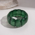 Detailed view of the wide stretch bracelet featuring glittering emerald green resin tiles - Green