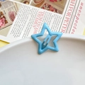 Sky blue star-shaped metal hair clip on a white ceramic plate with retro newspaper - Light Blue