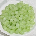 Detail of 6x8mm light green translucent faux jade beads in a white shell-shaped bowl - Jade Color