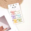 Close-up of six colorful butterfly hair clips on white card with matte resin finish - 3D Macaron