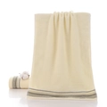 Thick light yellow 100% cotton towel with fine terry texture and striped hem edge - Gift Cream