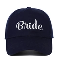 Detailed close-up of white cursive Bride embroidery on a navy blue cotton baseball cap - Bride (BRIDE) / Navy Blue