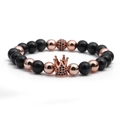 Detailed view of rose gold crown charm with black zircons on a beaded stone bracelet - Dark Blue Tiger Eye Rose Gold