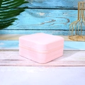 Small square jewelry box in light pink faux leather with a zip closure on wooden surface - 10x10x5cm / Light Pink