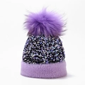 Close-up of purple knit winter hat with colorful sequins and a large faux fur pom-pom detail - One Size / Purple (Dyed Pom Pom)