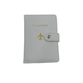 Close-up of white PU leather passport cover with gold plane logo and snap fastener - Standard Type / Ivory White
