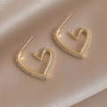 Close-up of golden heart earrings with zircon studs on soft beige silk background - Gold Heart Earrings (S925 Silver Pin)