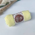 Detailed close-up of light yellow wrinkle cotton scarf with natural pleated texture and label - Style #55