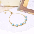 Macro detail of heart-shaped evil eye bracelet with cubic zirconia and adjustable chain - Light Blue
