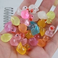 Close-up of colorful glowing resin mini ducks held in hand for DIY micro landscape crafts - Luminous Mixed Color Ducks