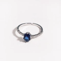 Detailed close-up of oval blue zircon silver ring with small diamond accents on white base - Dark Blue Gemstone Silver Plated