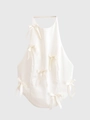 Vista dettagliata del top bianco crema con delicate decorazioni a fiocco in raso - XS / Bianco