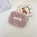 Close-up of plush leopard print organizer with zip closure and minimalist brand label - Purple Pink
