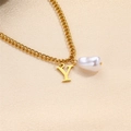Golden pearl necklace with letter Y pendant on champagne textured background - Letter Y Necklace