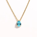 Detail of gold chain necklace featuring a teardrop blue zircon stone in 4-prong setting - Deep Sea Blue Teardrop