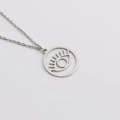 Detailed close-up of a minimalist hollow evil eye pendant on a fine stainless steel chain - Steel Color