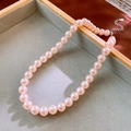 Detailed macro view of S925 silver clasp and pink-purple pearls on a velvet jewelry tray - 10mm Pink-Purple Pearl S925 Clasp / Pink