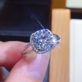 Close-up of a silver halo engagement ring with a round brilliant moissanite stone - 2 Carats [8mm] Ljz-212 / Adjustable Open