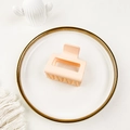 Detail of a matte light pink square hair claw clip with a hollow minimalist design - Off White