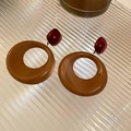 Close-up of brown resin heart earrings with gold metal accents on glass tray - 15# Silver Needle - Coffee Brown Round