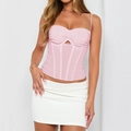 Detail of pink corset top with ribbon lacing and delicate straps on white background - S / Pink