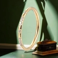 Slim gold stainless steel ring with micro-pave round zircons on a dark green surface - US 5 / Eternity Band Style / Gold