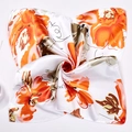 Macro view of silky square scarf featuring vibrant orange flowers and modern chain patterns - Orange Big Flower