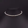 Elegant single layer round freshwater pearl necklace displayed on a black velvet stand - Minimalist Beaded Style