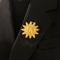 Detail of vintage gold sunburst brooch featuring a smiling face on black blazer - Vintage Sun Face Style (06 Titanium Gold 6251)