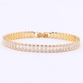 Close-up of gold-plated tennis bracelet featuring rectangular white cubic zirconia stones - Square Clasp Gold-White