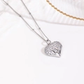 Macro shot of silver heart pendant featuring sparkling cubic zirconia and 18k plating - Liquid Metal Zircon Heart Necklace / Silver