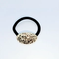Elastic black hair tie featuring a hammered gold oval metal plate for women - Oval Hammered Decorative Piece (Hair Tie 75)