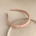 Elegant pink satin headband with white pearls and square beads on a ceramic plate - Pink