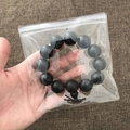 Black round bead bracelet with lucky knot inside a transparent PVC jewelry storage bag - 100 Pieces / 13*13cm (26 Microns)