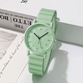 Detail of mint green quartz watch with wavy silicone strap and minimalist round dial - Green