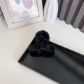 Black faux rabbit fur large claw clip for thick hair styling in a minimalist setting - Black