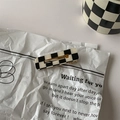 Close-up of black and white checkered rectangle hair clip on a vintage paper background - 16# Duckbill Clip - Hollow Square
