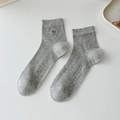 Gray rib-knit crew socks with delicate dark embroidery on a clean white background - One Size / Light Gray