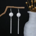 Detailed close-up of vintage flower silver earrings with long fringe tassels on wood - Exquisite Flower Long Tassel Style (E5198-2)