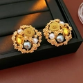 Detail of vintage flower earrings with pearls and yellow gemstone on black leather - Style 72# S925 Silver Pin Gold Liquid Metal Wave Earrings