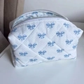 Quilted white cosmetic bag with blue bow pattern and durable double zipper - Blue Polka Dot Bow