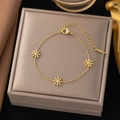 Detail of a gold stainless steel daisy bracelet on a jewelry display box - Three Daisy Flowers (E166) Gold