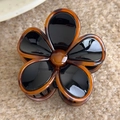 Detail of vintage amber flower hair claw clip on beige knitted fabric background - Black Flower Large