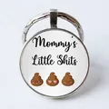Silver round keychain featuring Mommy's Little Shits text and funny cartoon emojis - Mommy's Little Shits/Cartoon Poop