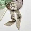 Cream silk twilly scarf with black bamboo ink pattern shown on a styled background - Misty Rain and Bamboo